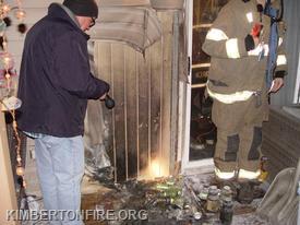 Chief Pollinger examines the area of Origin and fire damage.